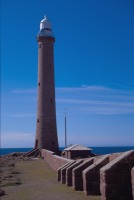 The brick wall leading to the tower, built to give shelter from the winds